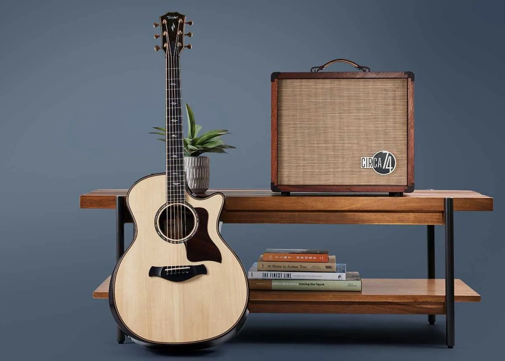 Taylor Circa 74 amp on table with acoustic guitar