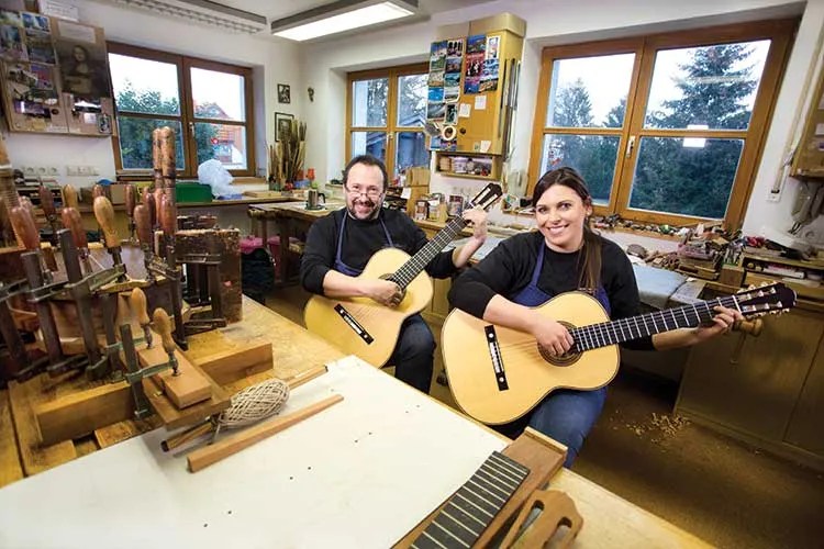 Guitar makers Kathrin Hauser and father Hermann Hauser III with guitars in the workshop