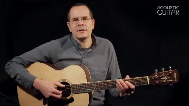 Acoustic Guitar editor Teja Gerken holding guitar for 11 affordable small bodied flattop guitars