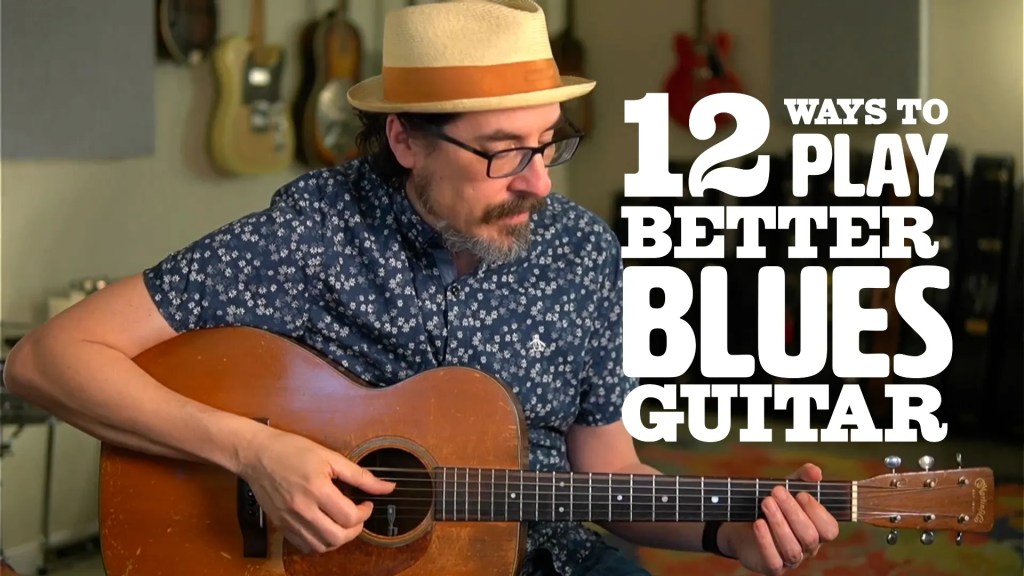 David Hamburger playing his guitar with the series name "12 Ways to Play Better Blues Guitar"