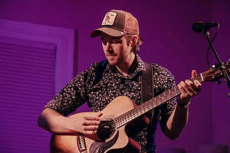 Joe Robinson with acoustic guitar