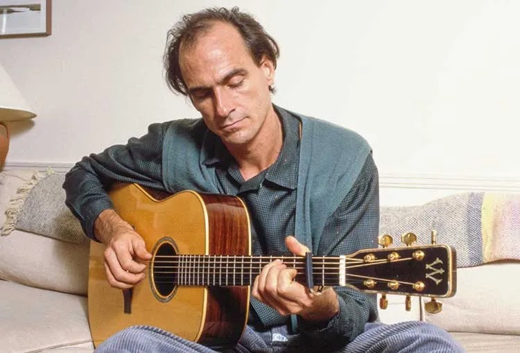 James Taylor playing guitar