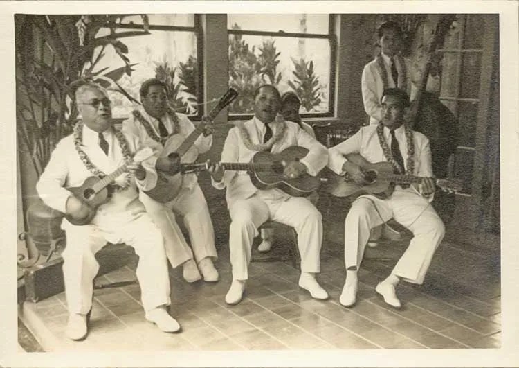 Hawaiian vocal quintet seated with guitars