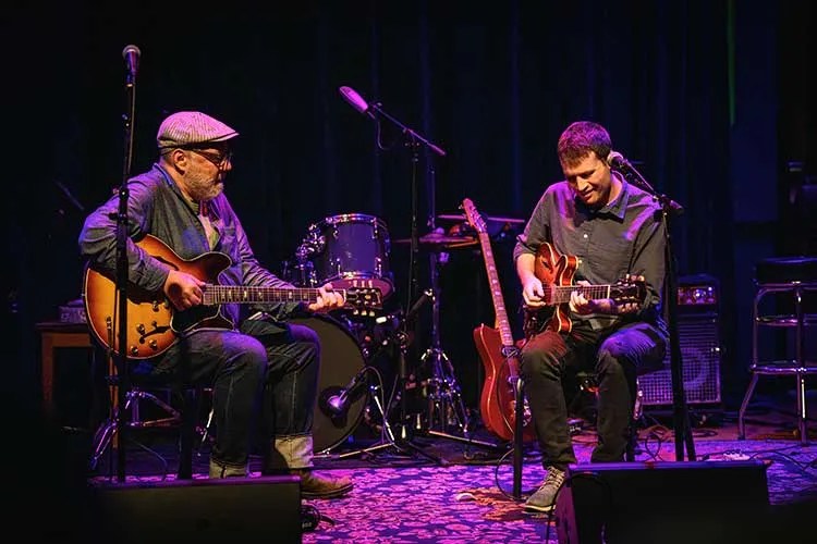 Adam Levy and Ethan Sherman playing guitars onstage. Photo by JOE BASTURA