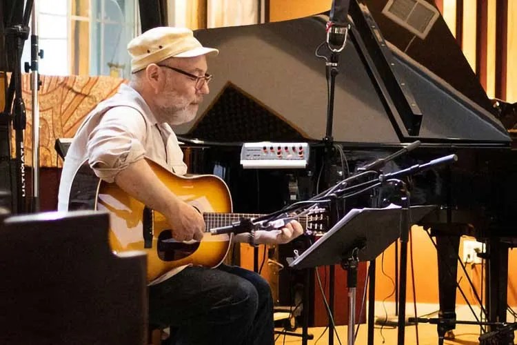 Adam Levy playing guitar in studio