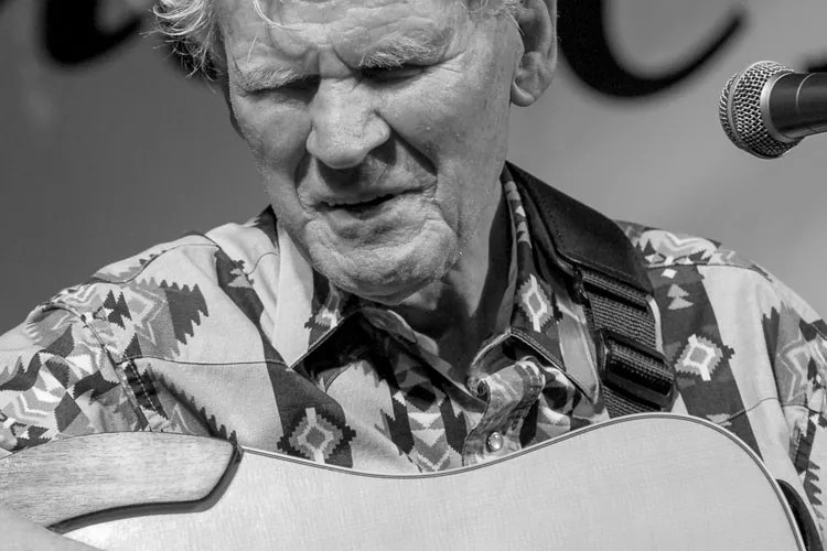 Doc Watson playing guitar.