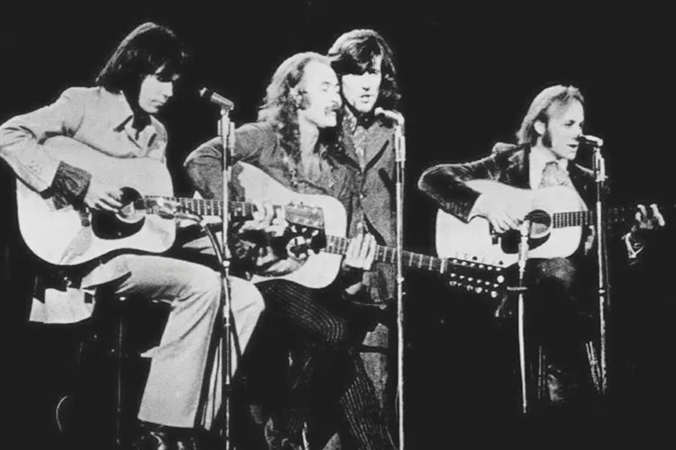 a row of guitar players onstage