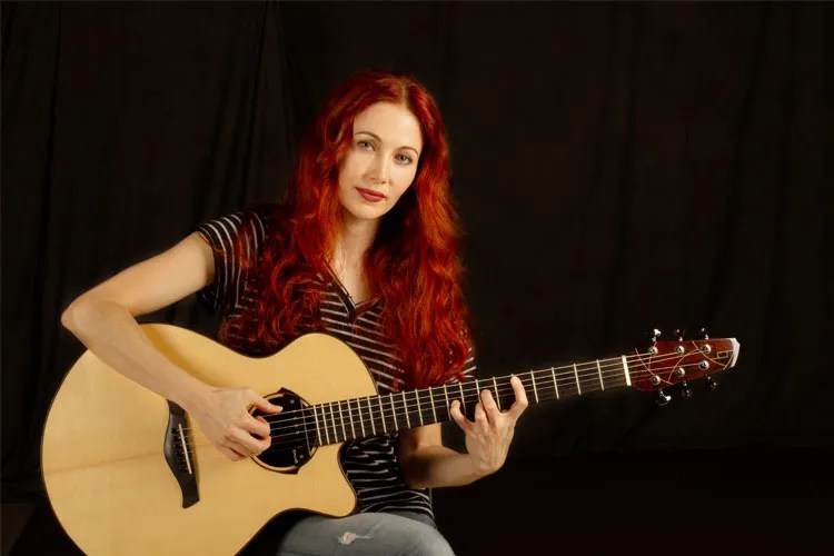 Gretchen Menn with acoustic guitar