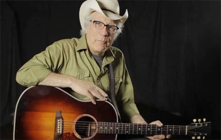 Maurice Tani with sunburst acoustic guitar