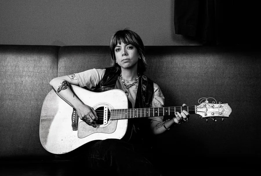 Alynda Segarra black and white photo with Guild guitar.