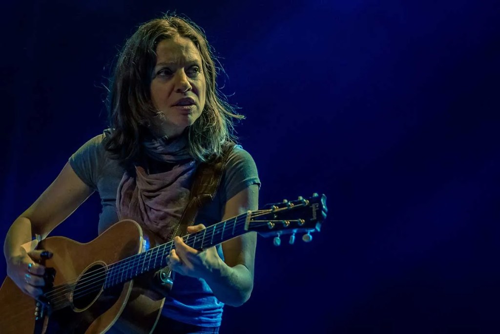 Ani DiFranco onstage with guitar. Photo by Anthony Mulcahy