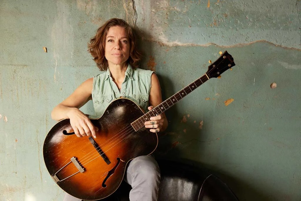 Ani DiFranco holding a archtop guitar. Photo by Danny-Clinch