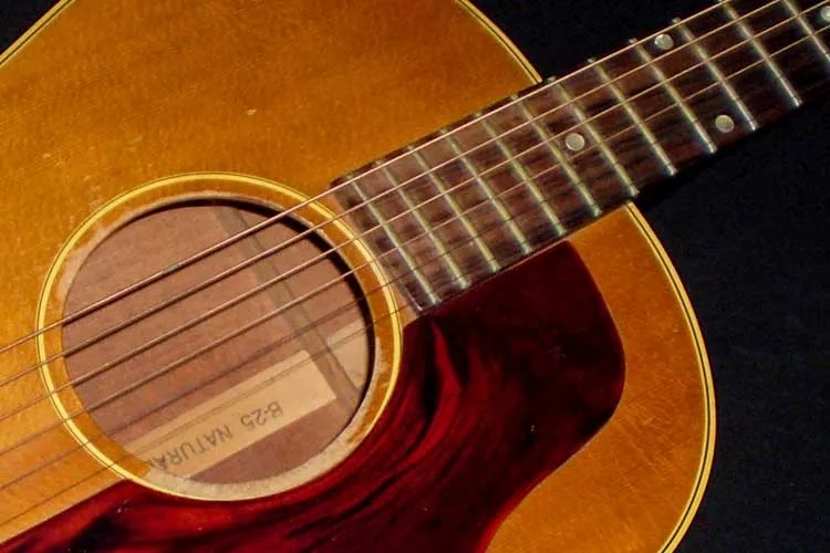 closeup of an Gibson B-25 acoustic guitar's top, soundhole, and neck-to-body connection