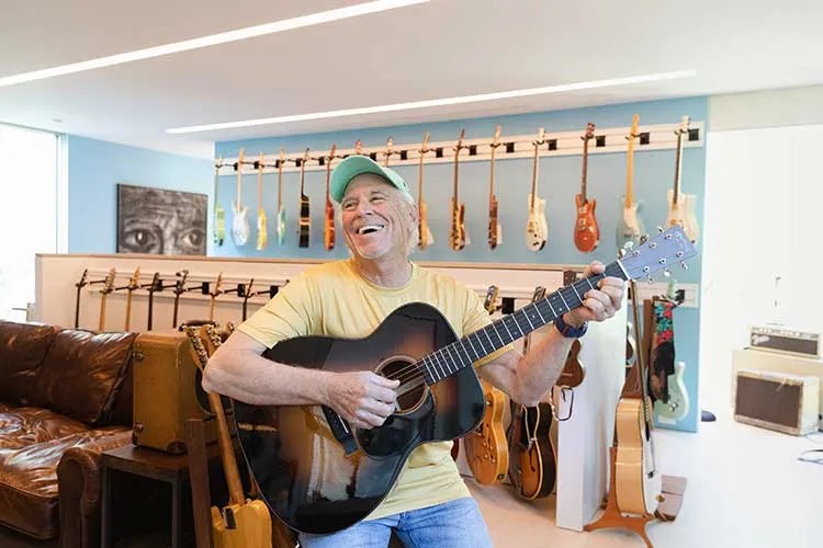 Jimmy Buffet at home with guitars