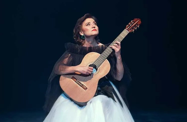 BERTA ROJAS onstage with guitar