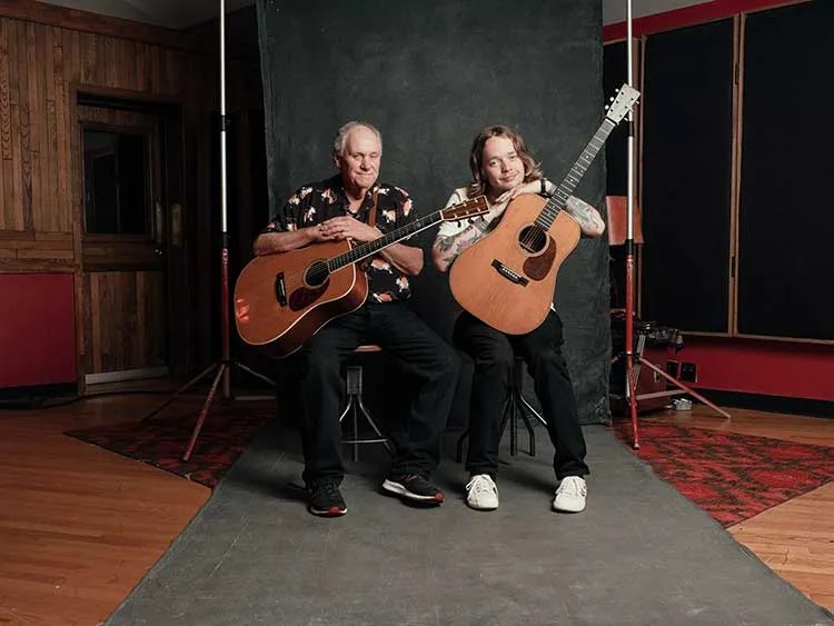 billy strings with stepdad terry barber holding guitars