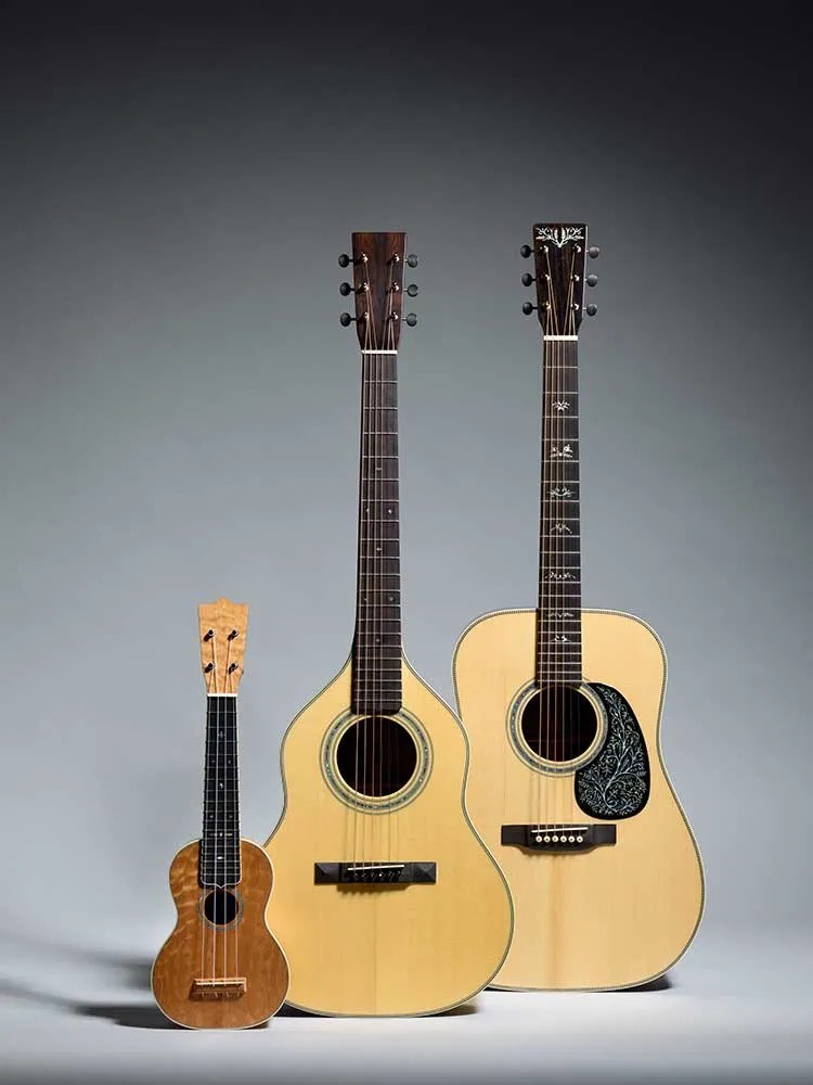 two guitars and a ukulele made by dick boak