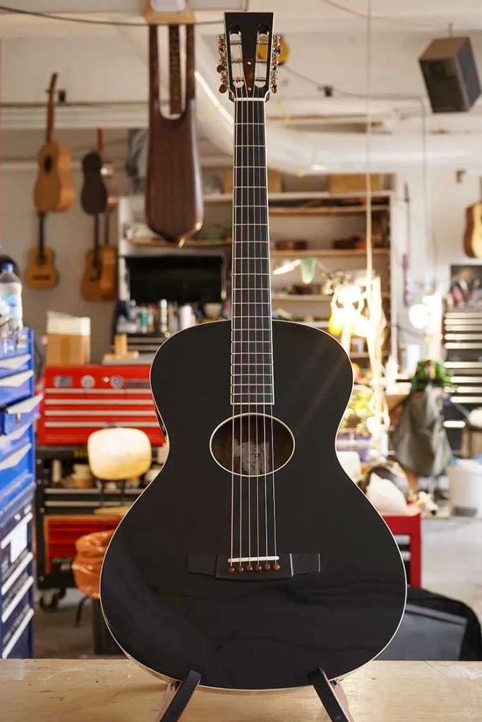 A black acoustic guitar by luthier Eve Meister