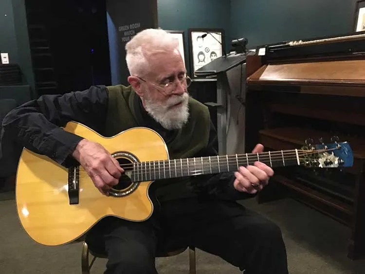 Bruce Cockburn with Linda Manzer's Sunflower Guitar for Ukraine