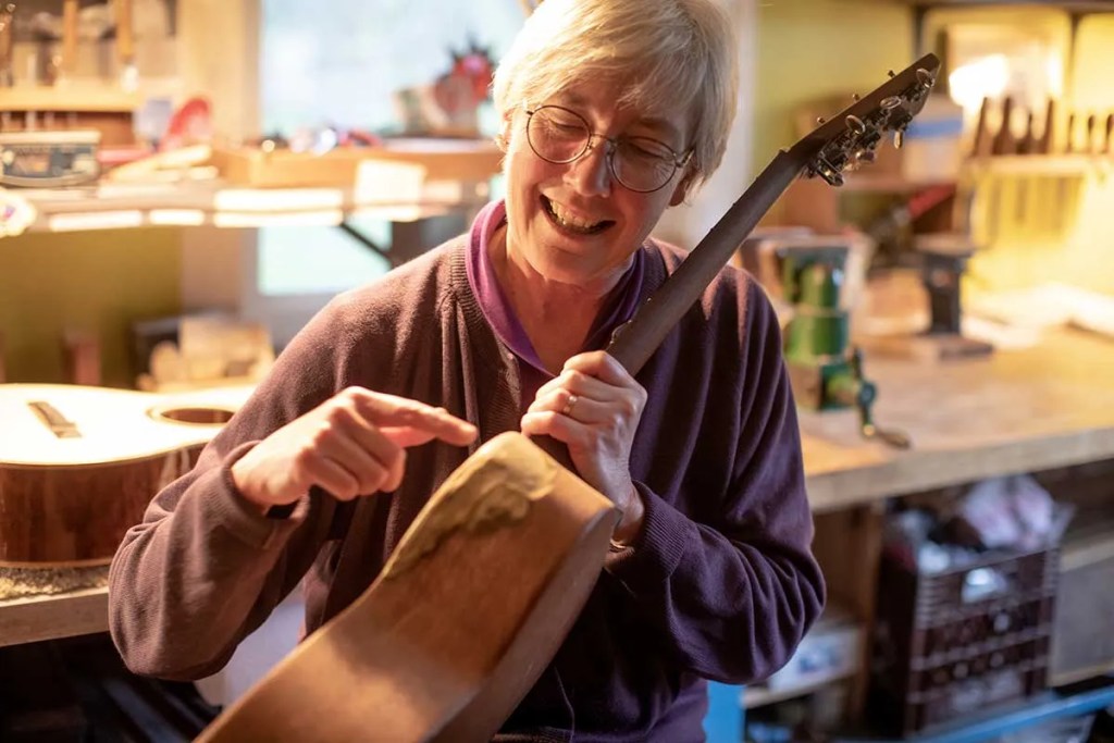 Cat Fox repairing an acoustic guitar