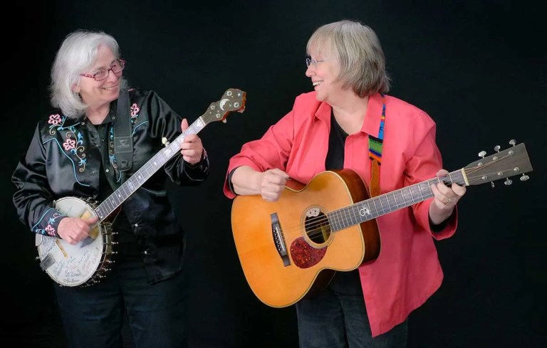 Cathy Fink (with banjo) and Marcy Marxer (with acoustic guitar) Photo by Irene Young