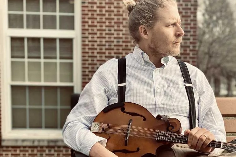 Guitarist C.E. Jones holding a mandolin