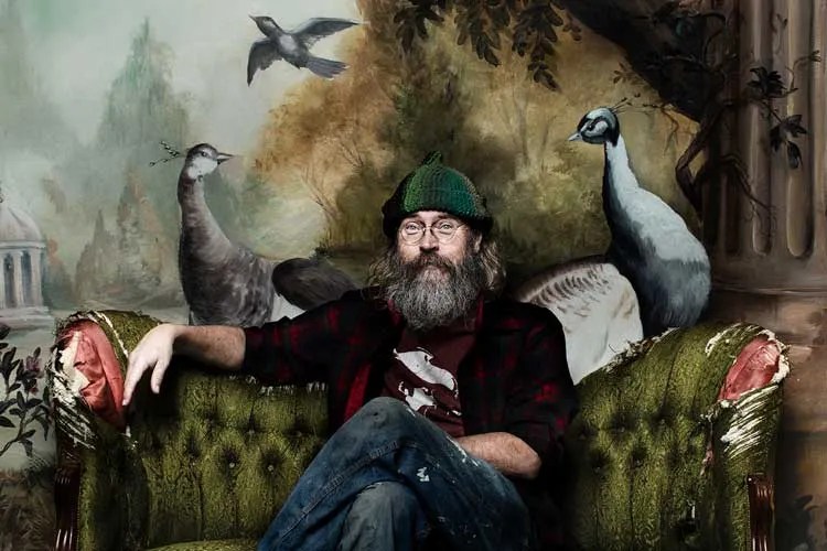 Charlie Parr sitting on couch with birds