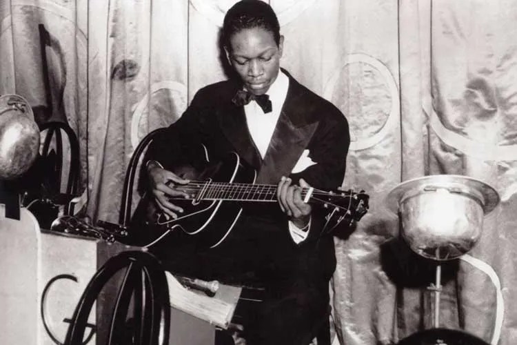 Charlie Christian playing guitar in black and white