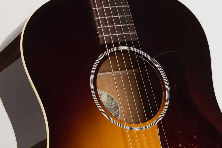 Collings CJ45 T acoustic guitar closeup showing the soundhole, strings, and sunburst finish