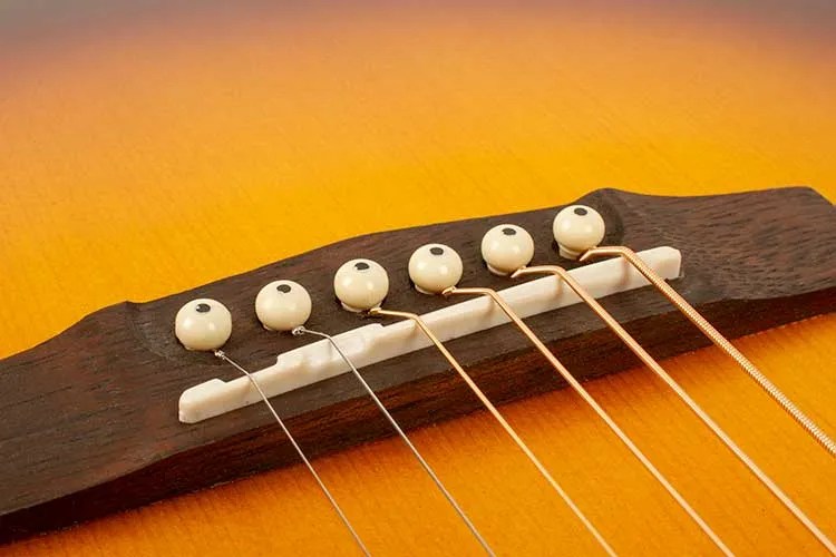 compensated bridge on acoustic guitar