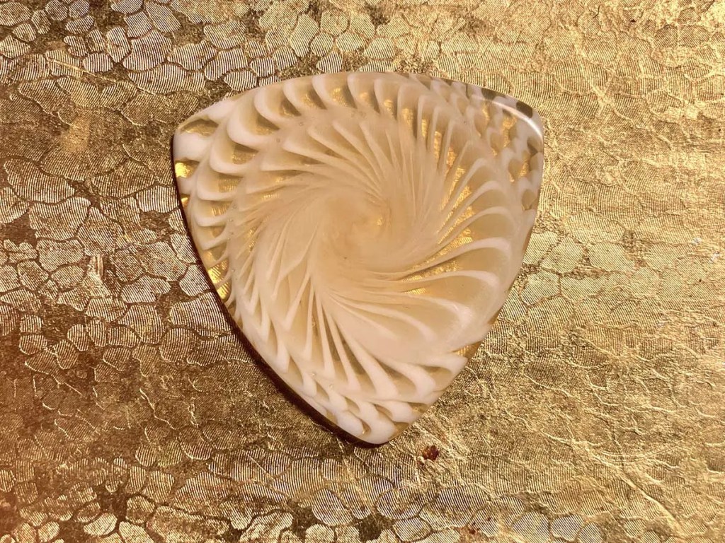 Conch Shell Casein Triangle pick from Charmed Life Picks