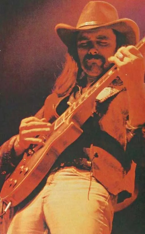 Dickey Betts onstage playing a Les Paul guitar