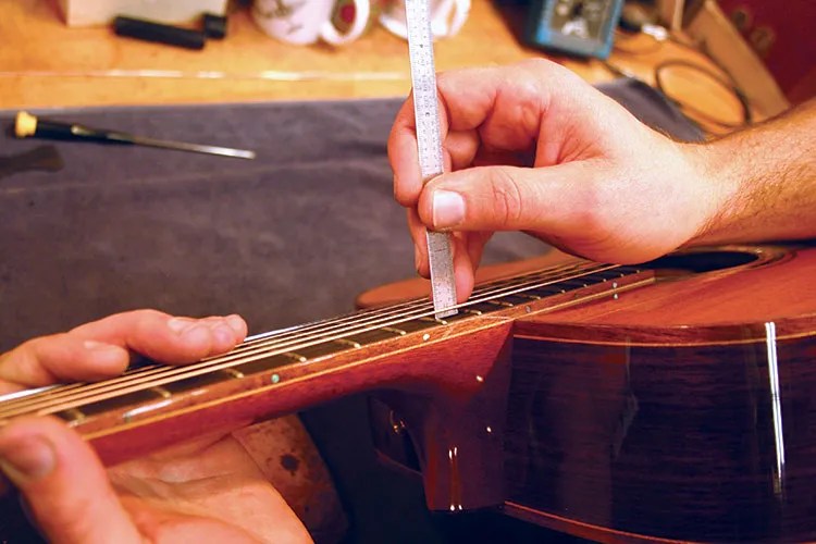 adjusting the bridge height on an acoustic guitar