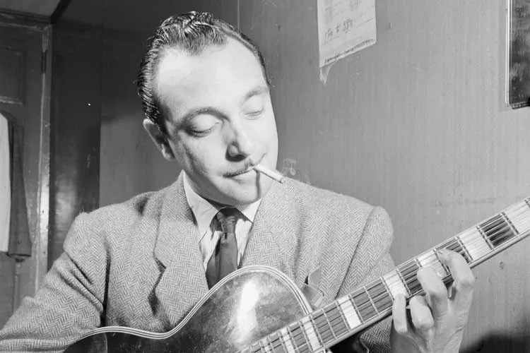 Django Reinhardt playing guitar while smoking a cigarette