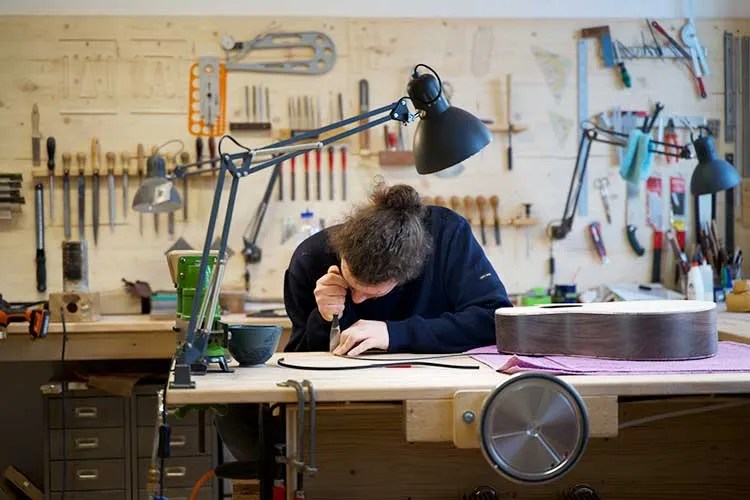 Luthier Max Spohn working at bench