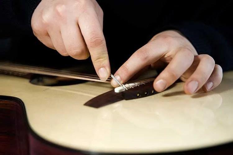 Luthier Max Spohn working on bridge