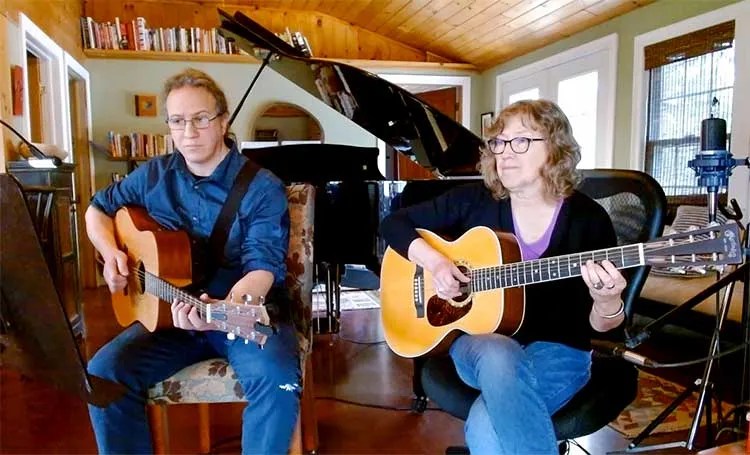 Brian Parent and Jane Miller playing duets on acoustic guitar.