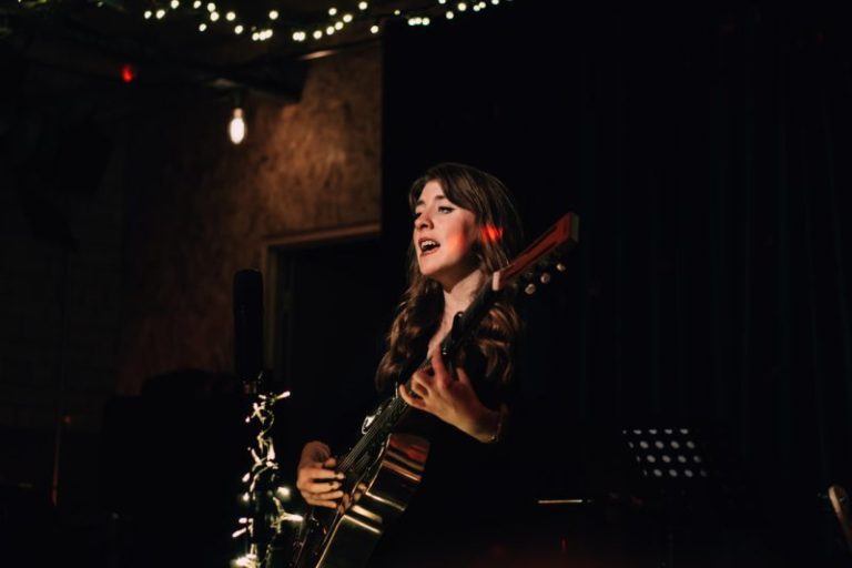 Elsie Franklin playing resonator guitar and singing