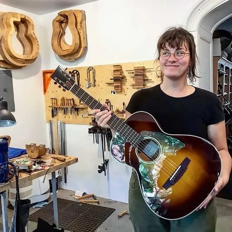 Luthier Eve Meister holds one of her acoustic guitars