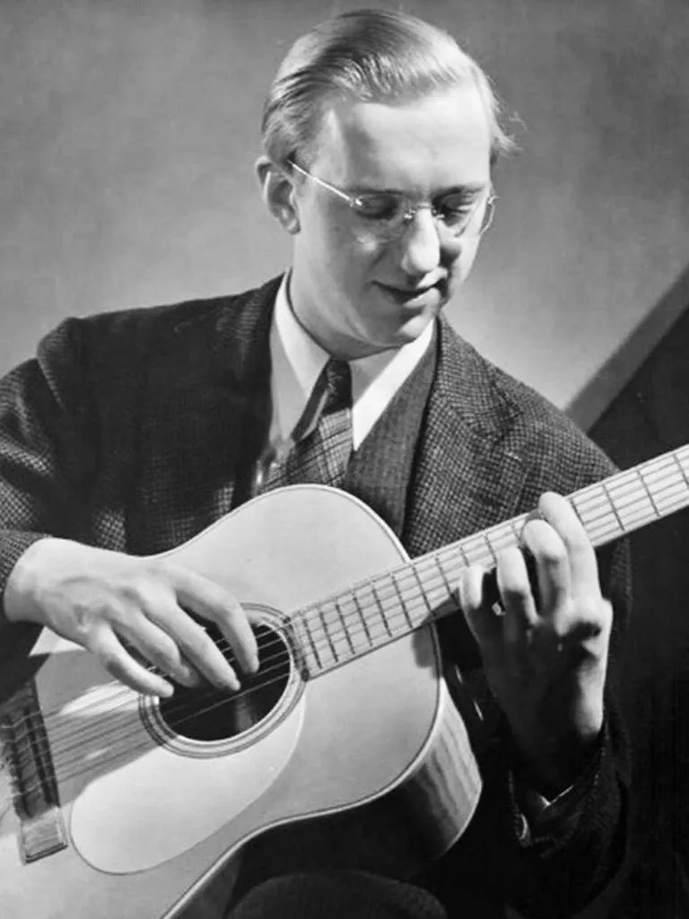 George Van Eps playing an acoustic guitar.