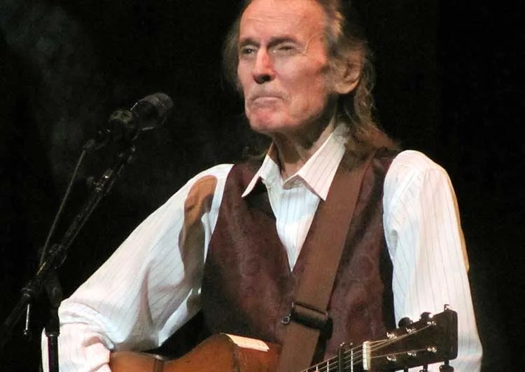 Gordon Lightfoot standing with guitar