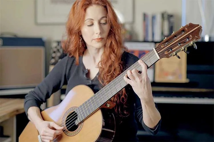 Gretchen Menn playing a Kenny Hill nylon-string guitar using tremolo technique. Photo by Daniele Gottardo