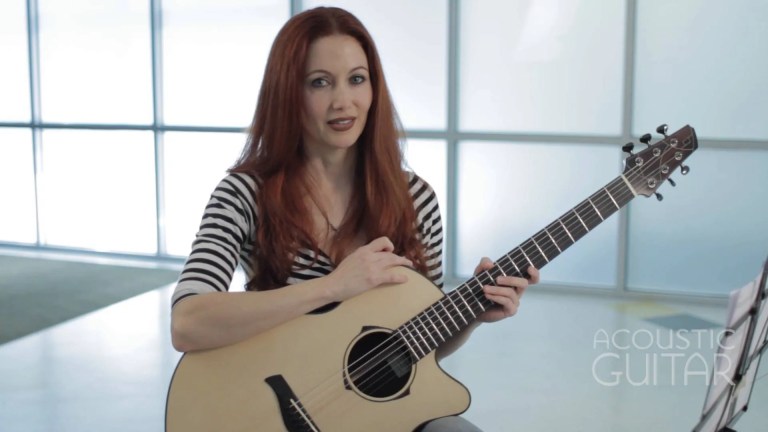 Gretchen Menn poses with acoustic guitar.