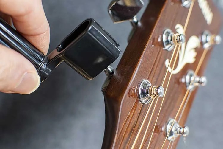 Guitar string winder in use