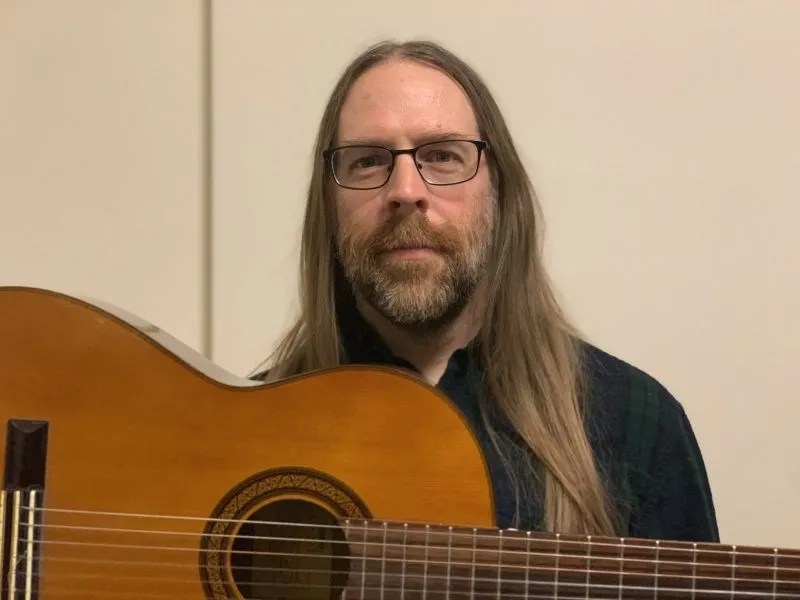 Guitarist Mick Barr with acoustic guitar