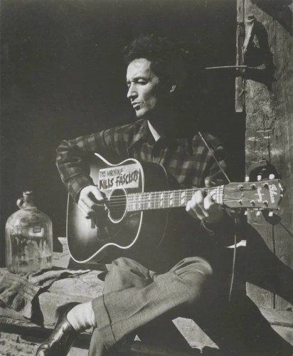 Woody Guthrie with guitar