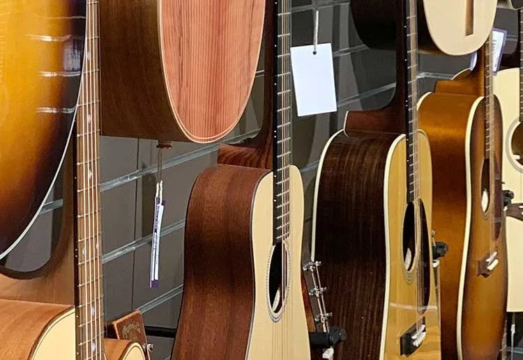 acoustic guitars hanging in a music shop