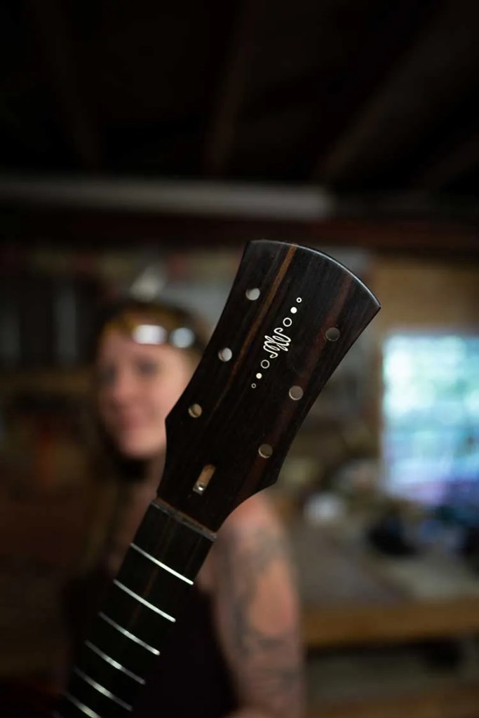 Close-up of an elegant headstock in progress on one of of Maegen Wells acoustic guitars