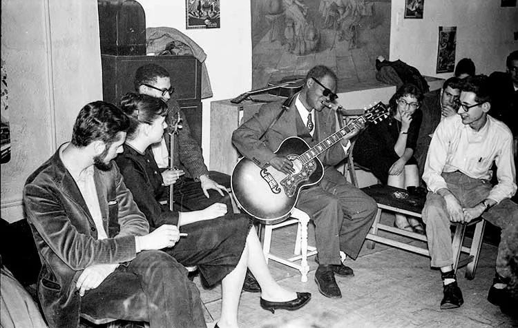 Reverend Gary Davis entertains guests at a party for his 63rd birthday, in 1959. 