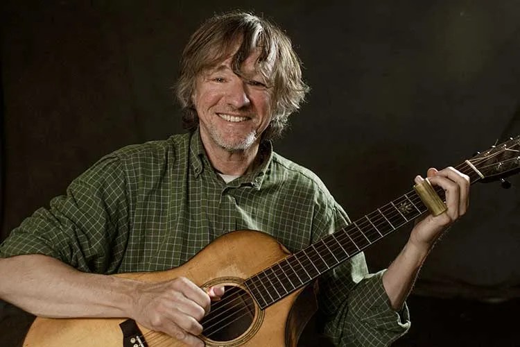 Steve Baughman with acoustic guitar